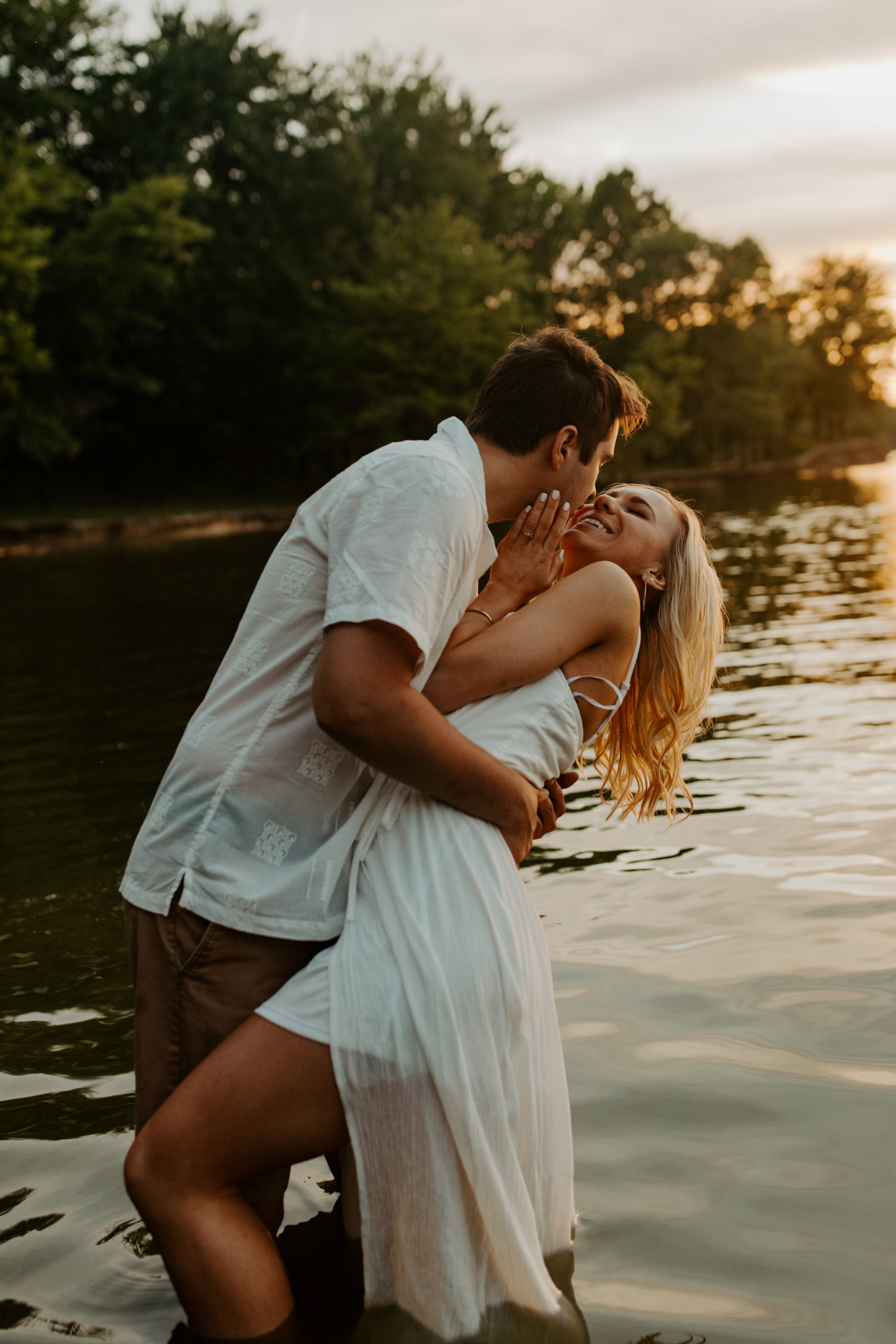 Engagement Photo of couple in all white dancing and kissing in water at East Fork Lake in Cincinnati Ohio 