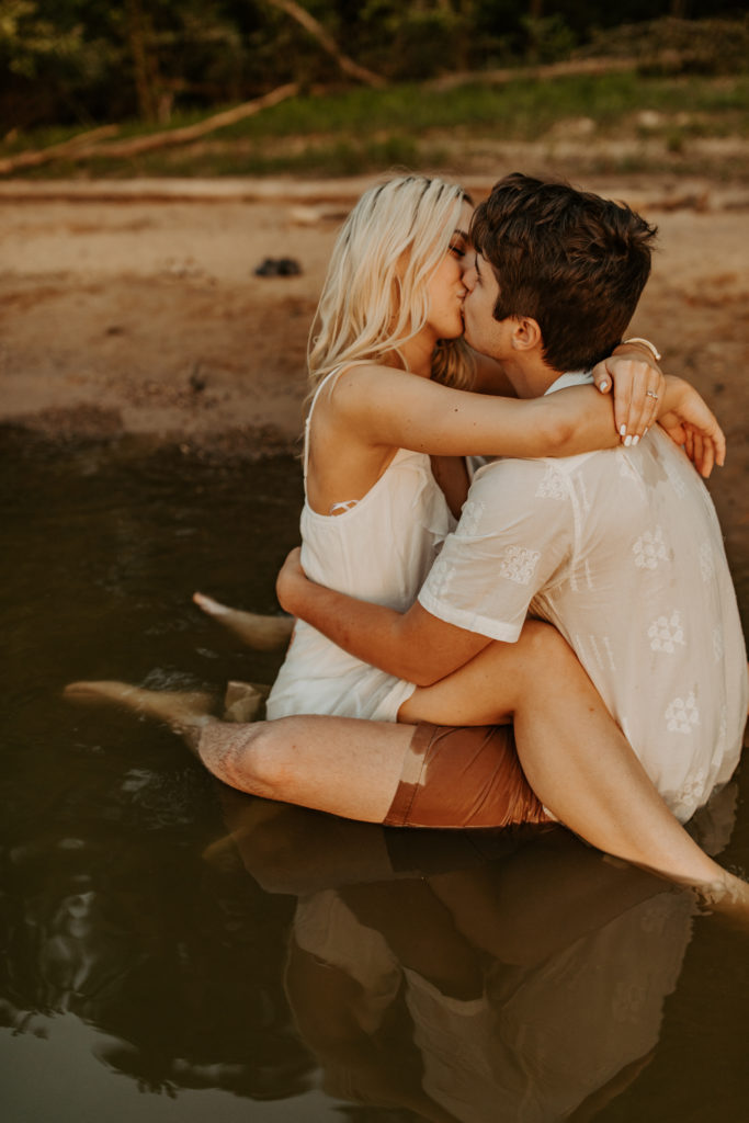 Kissing in water East Fork Lake Engagement