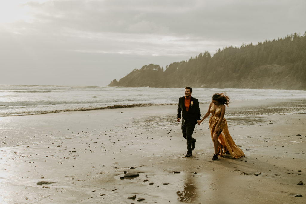 Couple sharing a sunset wedding walk on Short Sand beach during their Elopement in Oregon. 