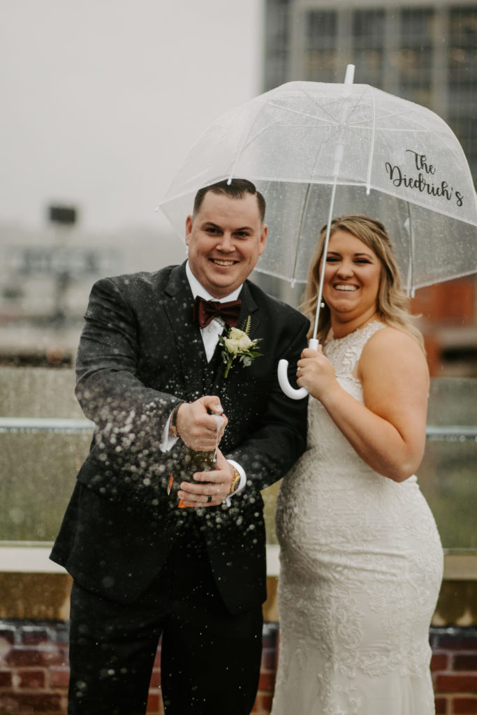 Champagne Pop after Cincinnati Elopement with wedding couple on a rooftop Lytle Park Hotel in Cincinnati Ohio. 