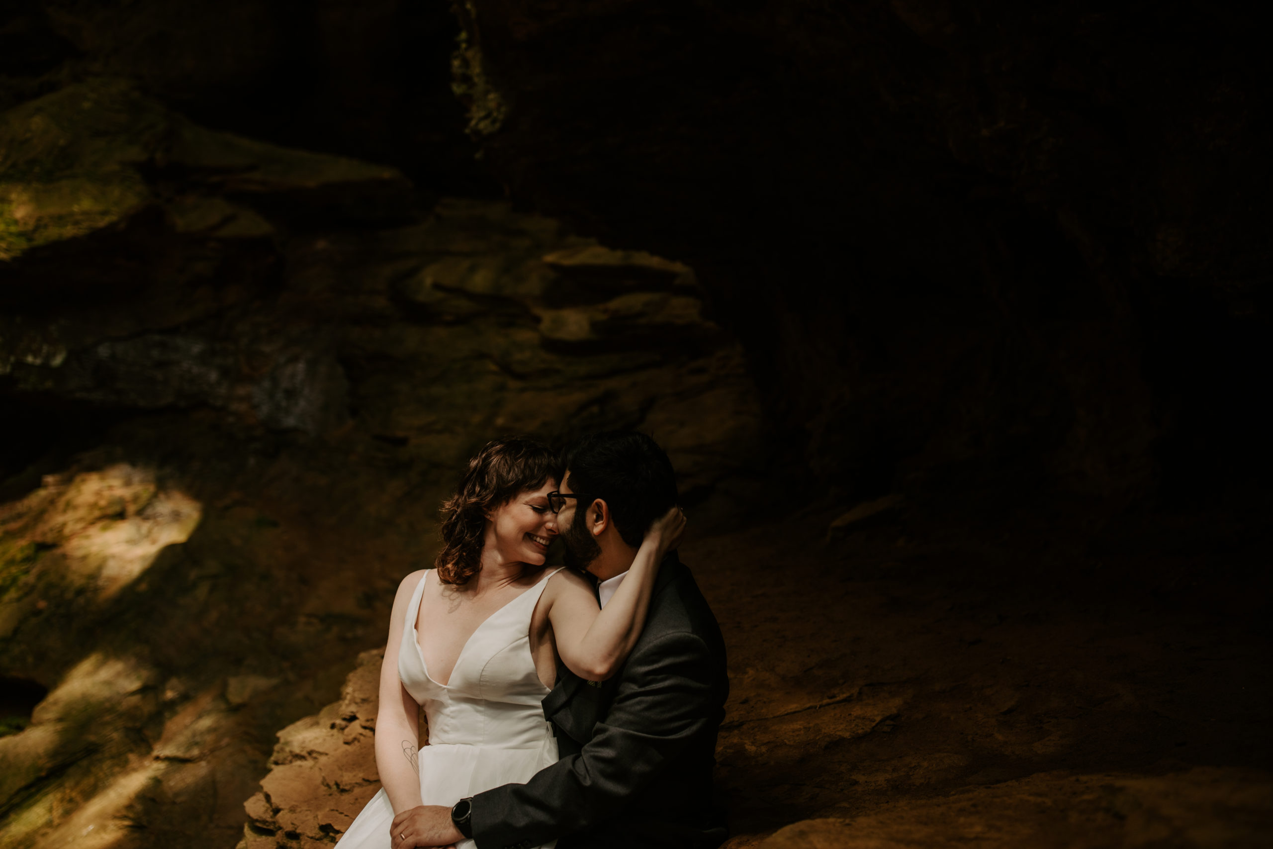 Wedding Couple snuggling outdoors in the rocks at the Conkle's Hollow Trail in Hocking Hills Ohio