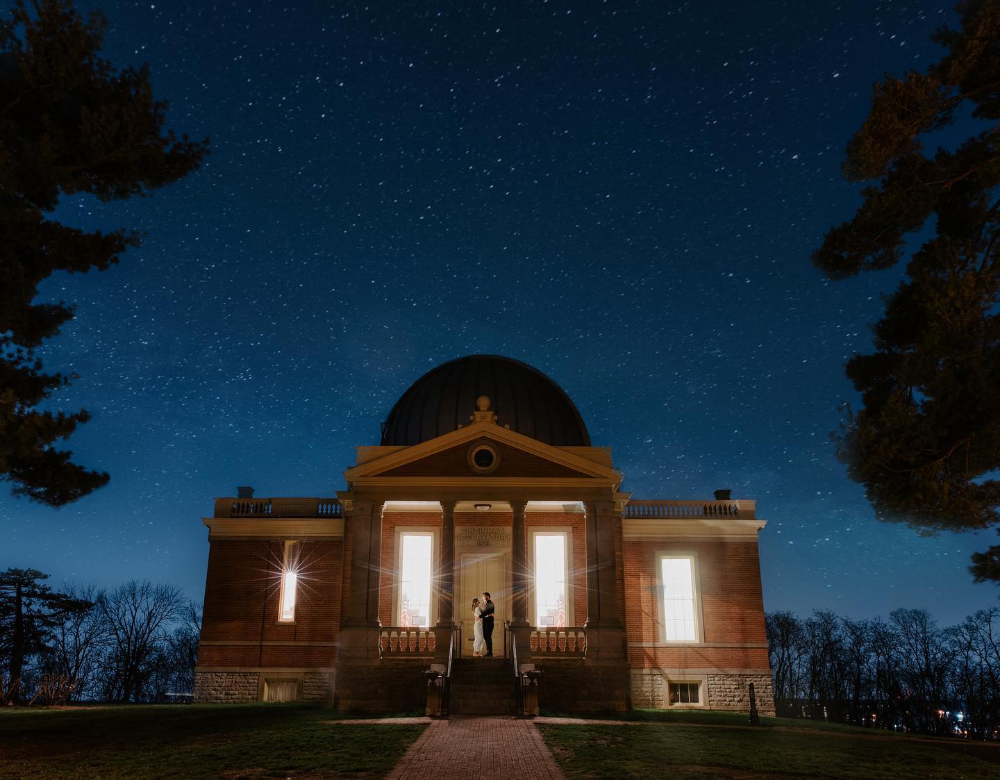 Engagement Photos under the night sky at an observatory. 