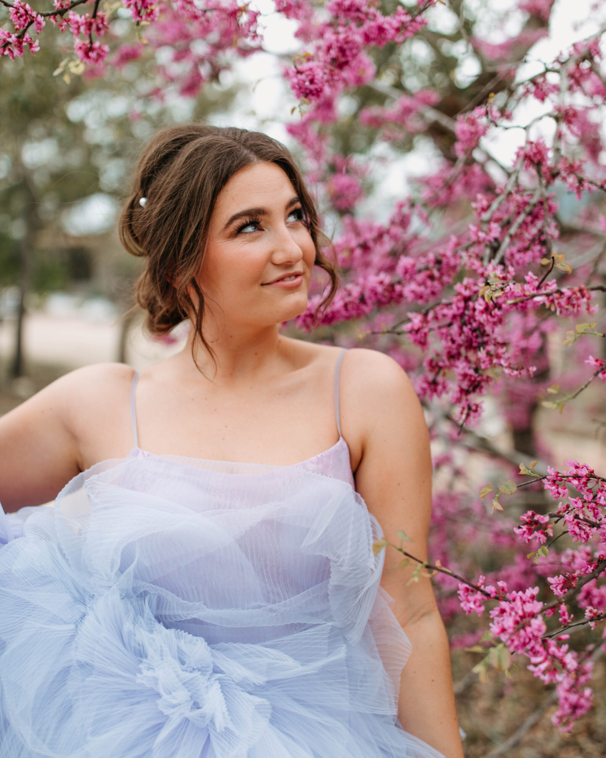 Bridal Portraits in the Spring in front of Blossoms. A spring wedding Inspiration photo.