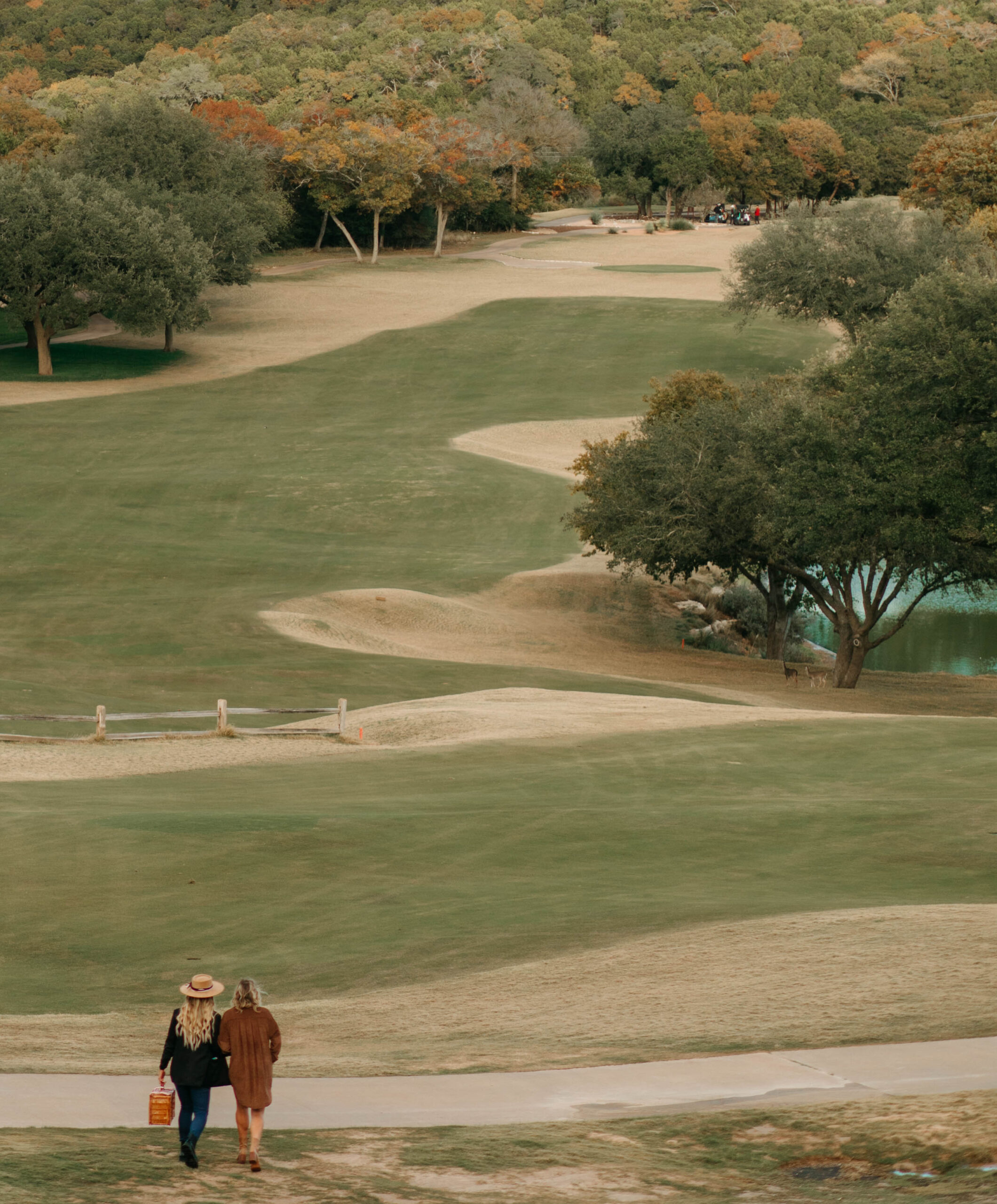A couple walking out towards the lake at Omni Barton Creek Resort for an Austin Proposal at sunset. 