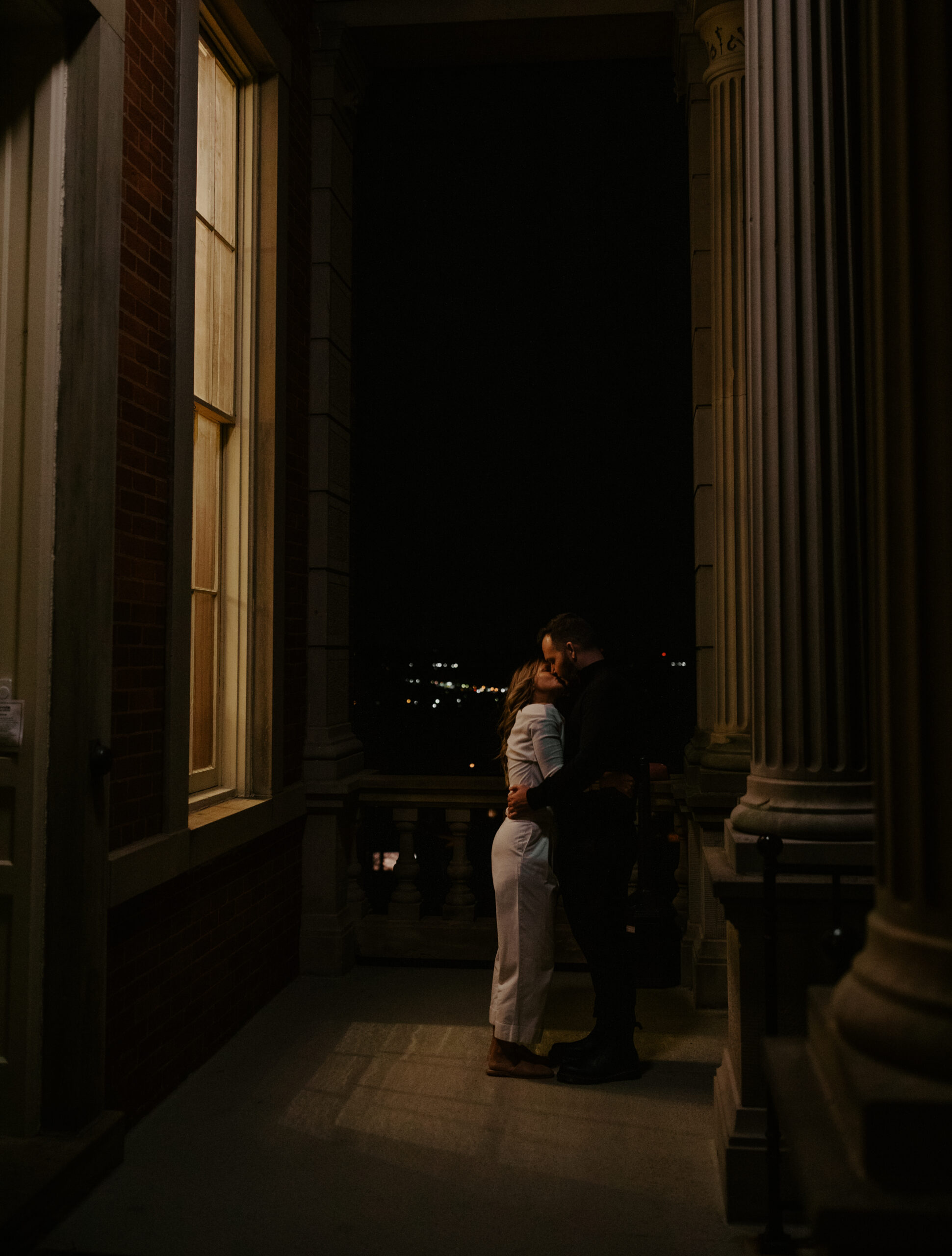 Couple kissing in the window light at the Observatory during their engagement session. 