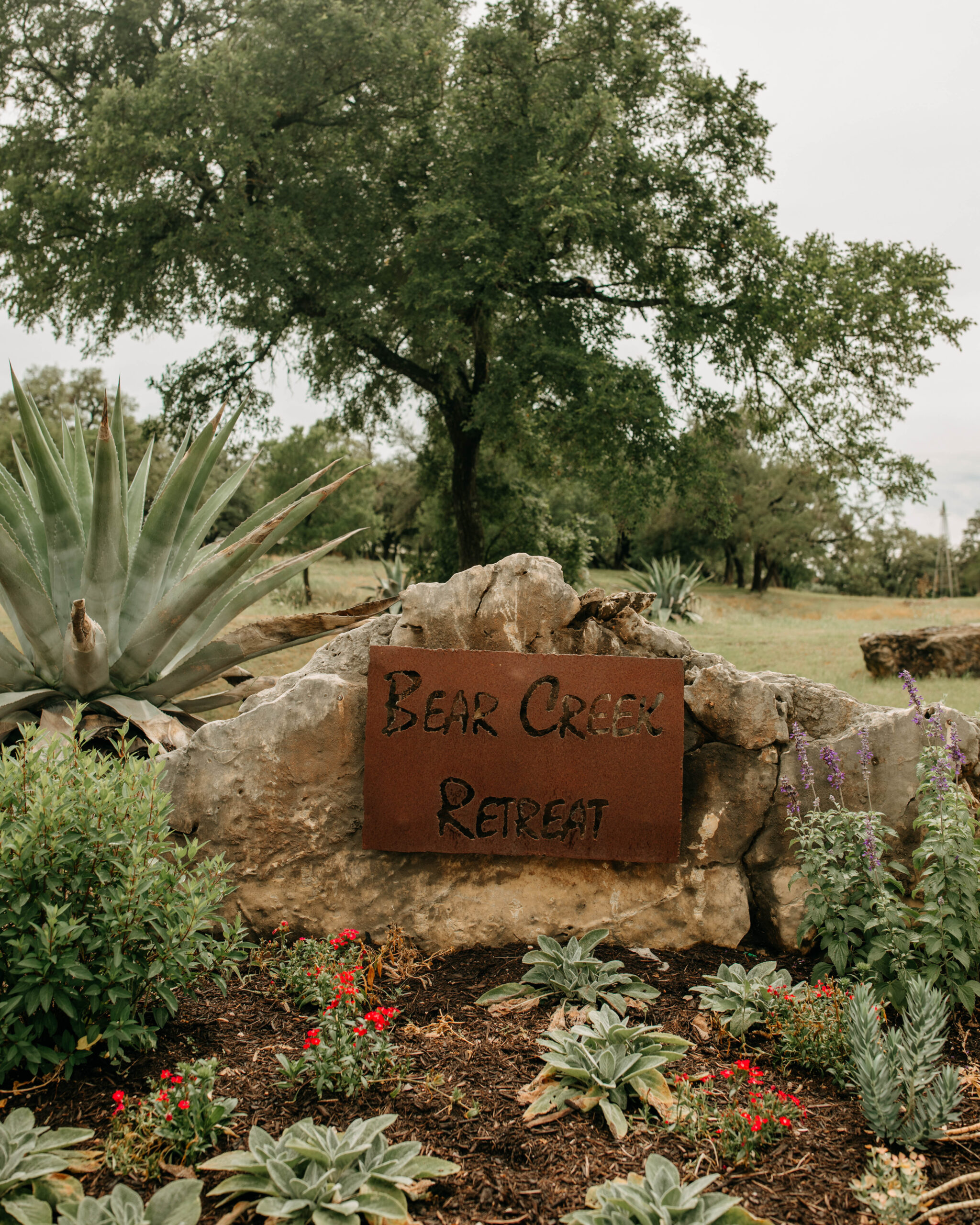 A Photograph of the Bear Creek Retreat signage outside of the Bear Creek Retreat Austin Wedding Venue. Taken on a wedding day in Texas Hill Country.