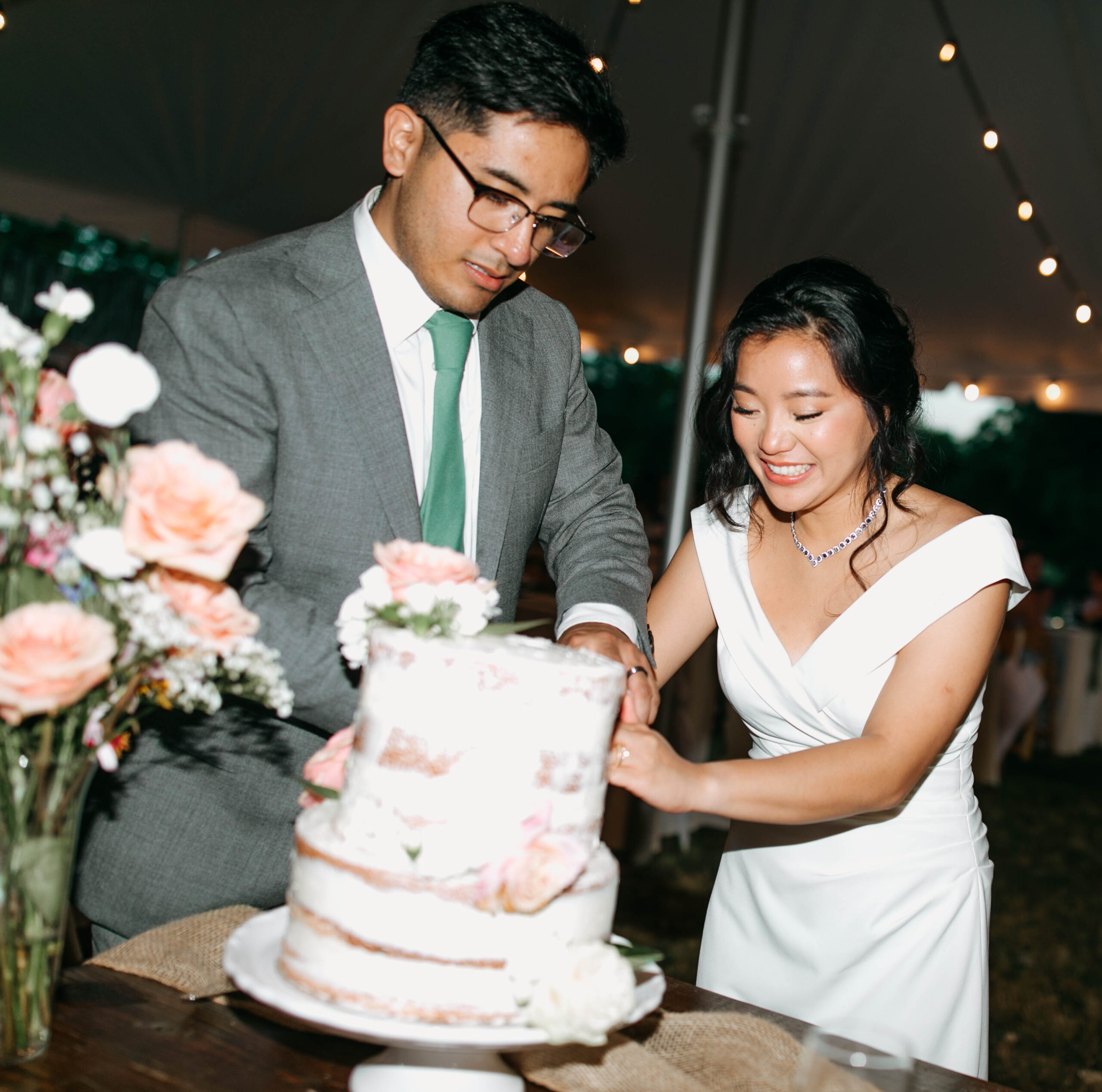 Austin wedding couple Joyce and Isaac cutting their naked cake at their reception.  