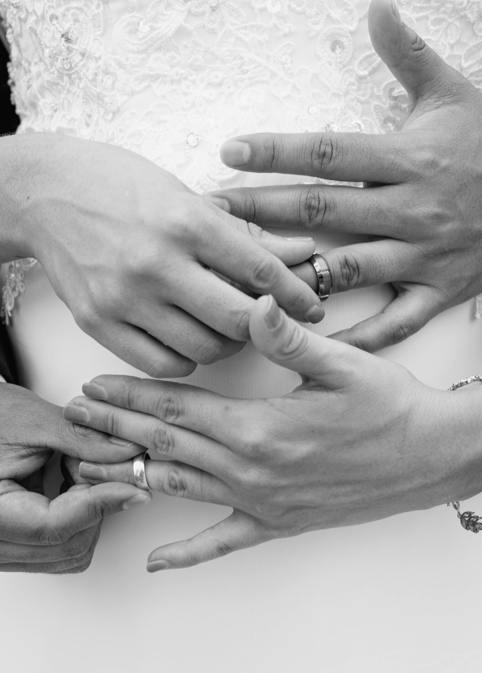 Detail photo of couple holding their wedding rings. 