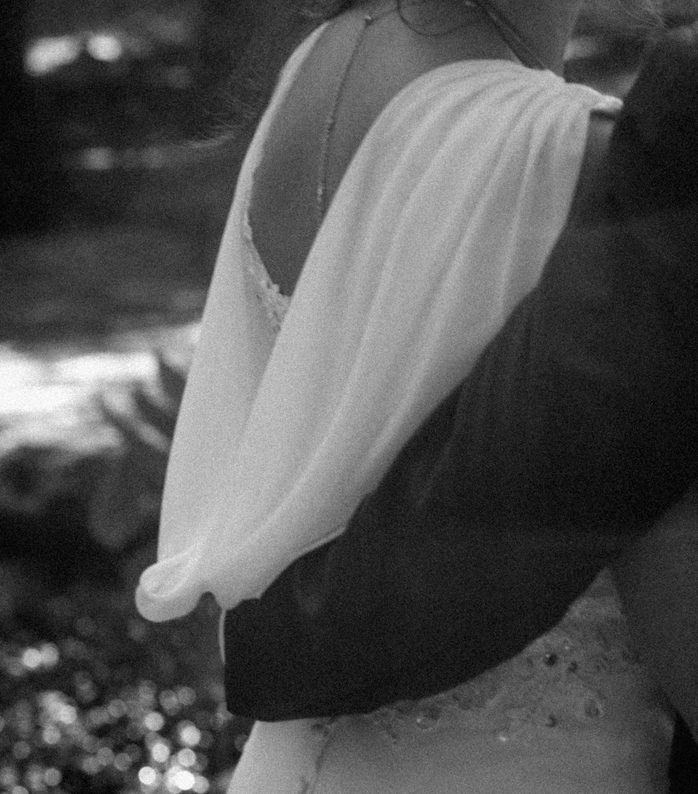 Black and White Wedding Photograph of a candid moment between a wedding couple. Photograph by Bare Moments Photography. Taken during the summer in Austin, Texas. 