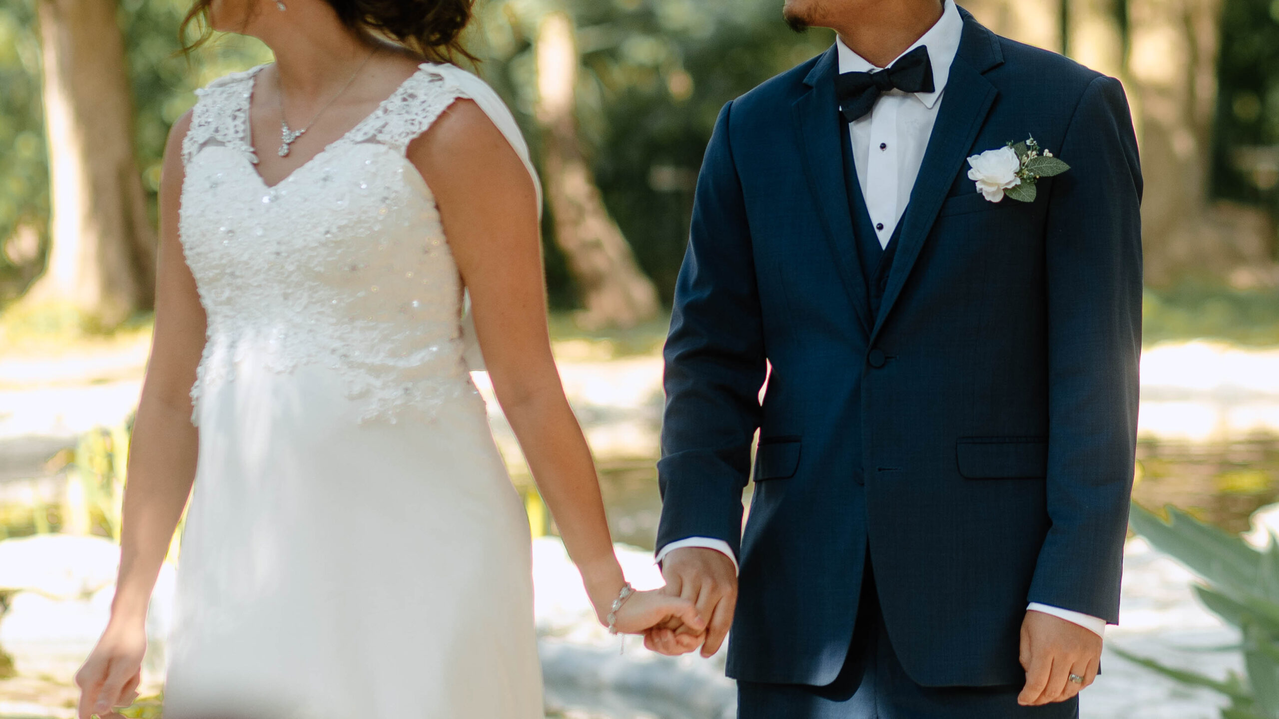Wedding couple holding hands. Taken at a Mayfield Garden wedding. 
