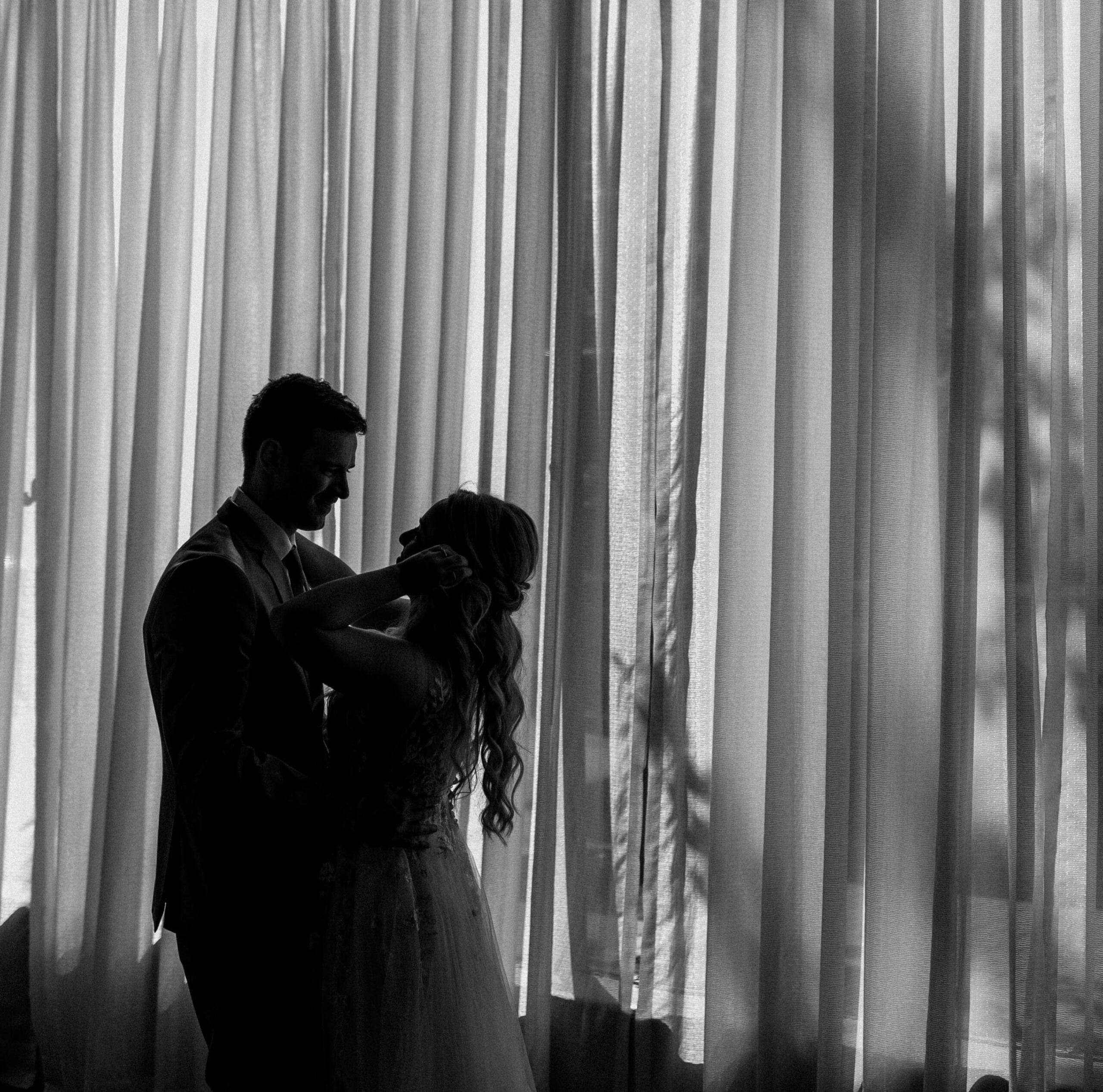 black and white candid photograph of weddings couple at the Madison Event Center. 
