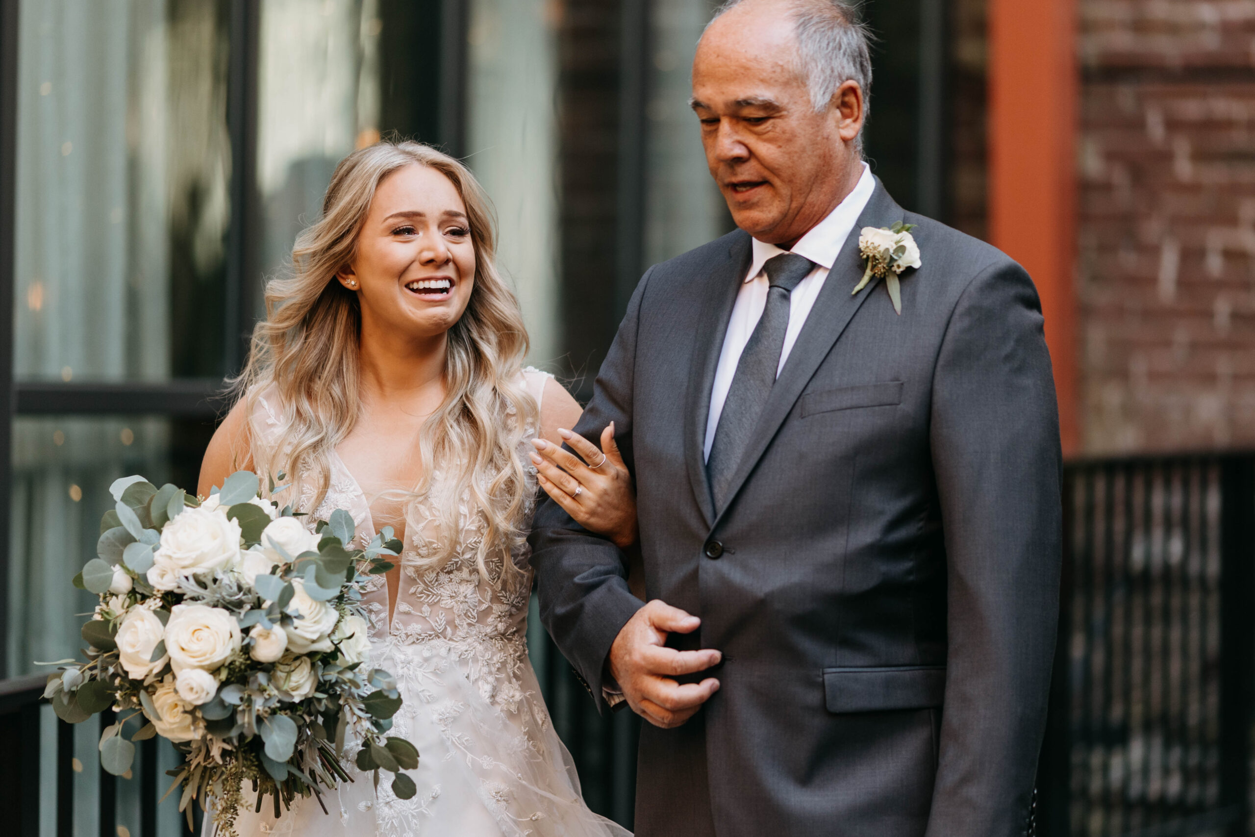 Bride's reaction to groom while walking down aisle. Documentary photograph of a wedding ceremony at Hotel covington courtyard.