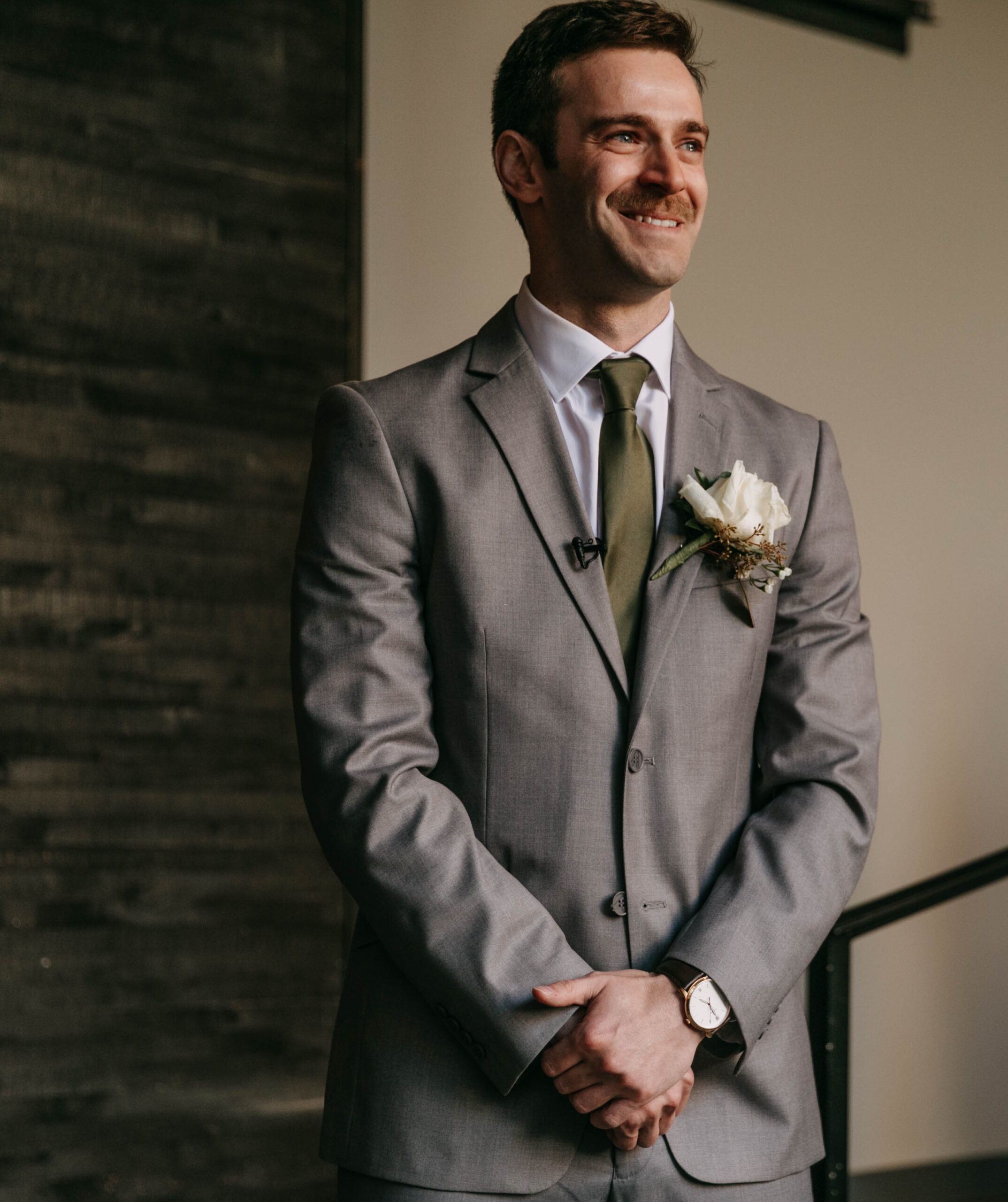 Groom's reaction photograph to bride walking down aisle. Documentary photograph of a wedding ceremony at Hotel covington courtyard.