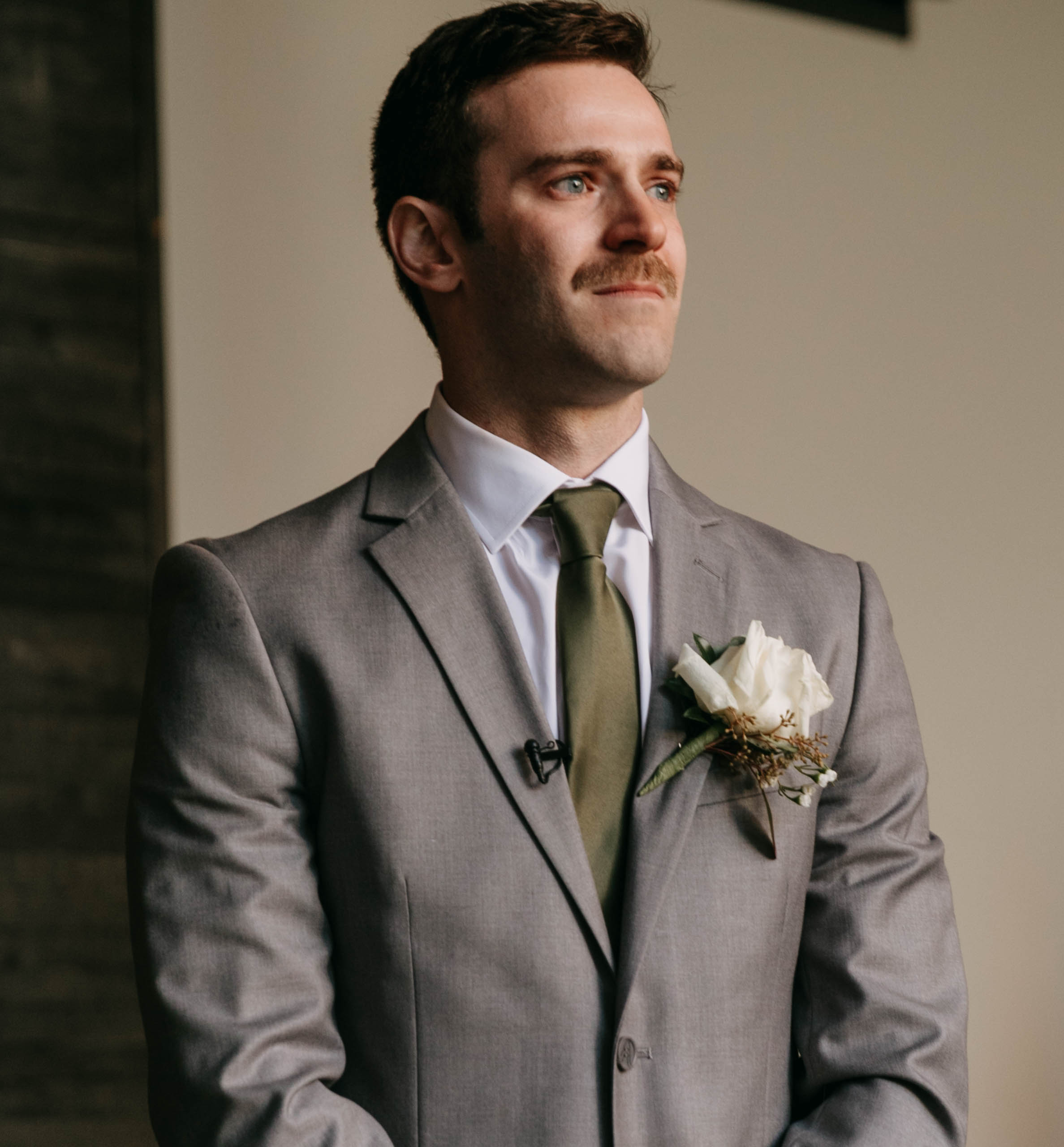 Groom's reaction photograph to bride walking down aisle. Documentary photograph of a wedding ceremony at Hotel covington courtyard.