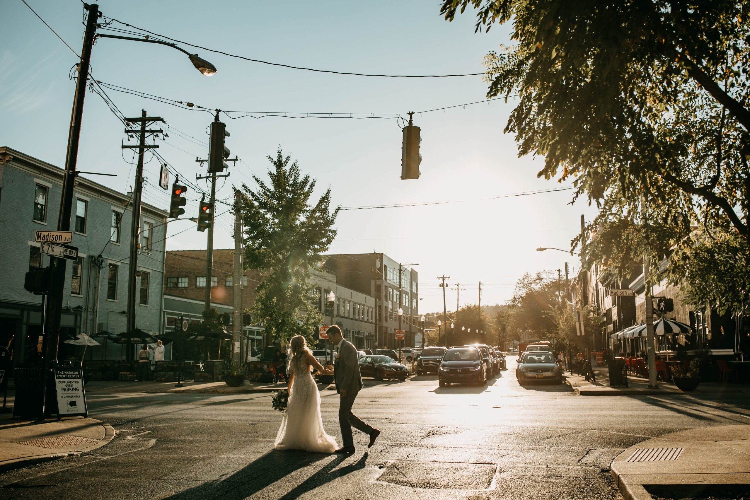 Candid photograph of married couple walking down city streets at their wedding. Taken in Covington Kentucky at Hotel Covington. 