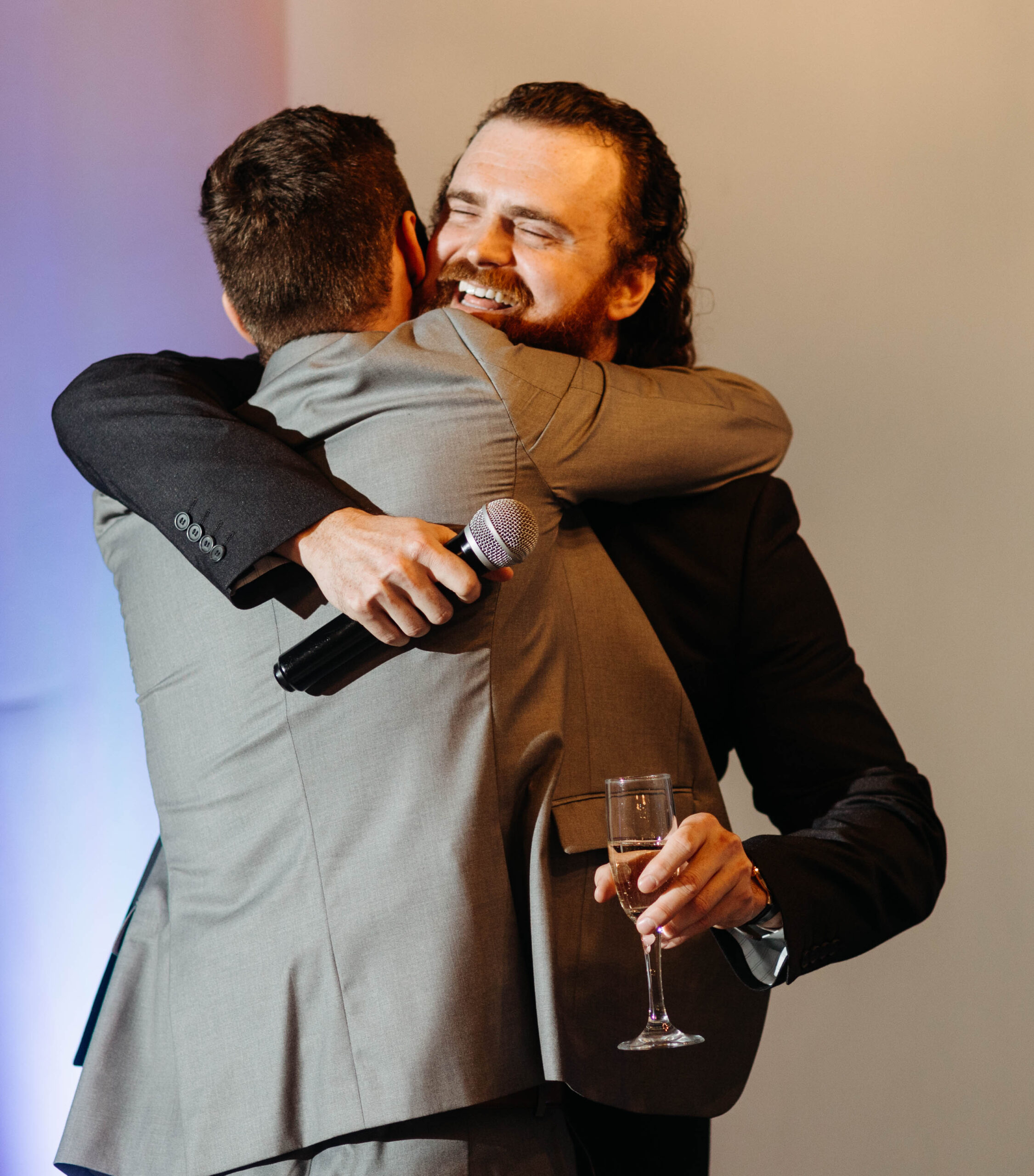 Candid wedding photograph of a couple laughing during their hotel wedding reception.