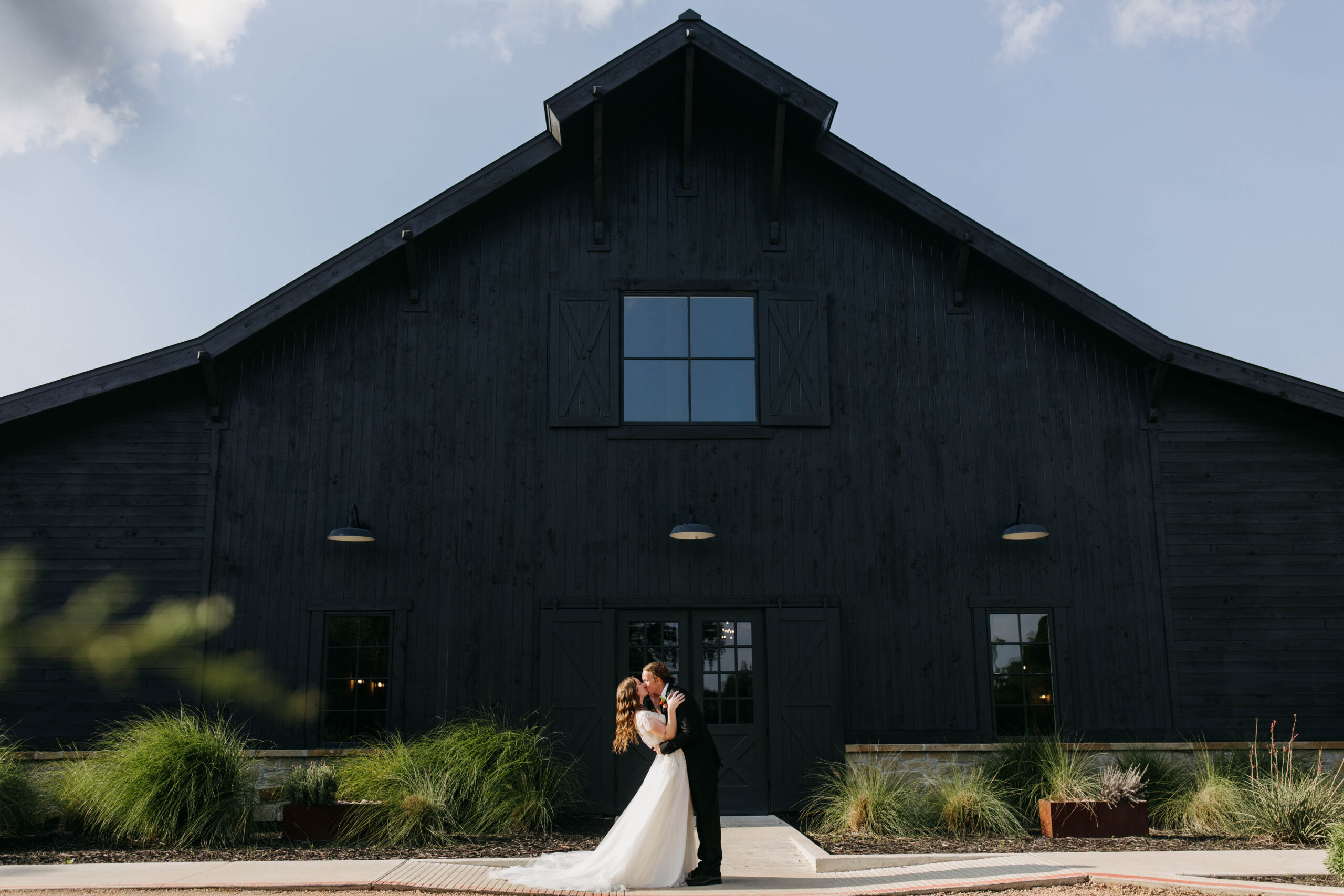 Couple in front of their wedding venue | Morgan Barn in Austin texas Wedding Venue