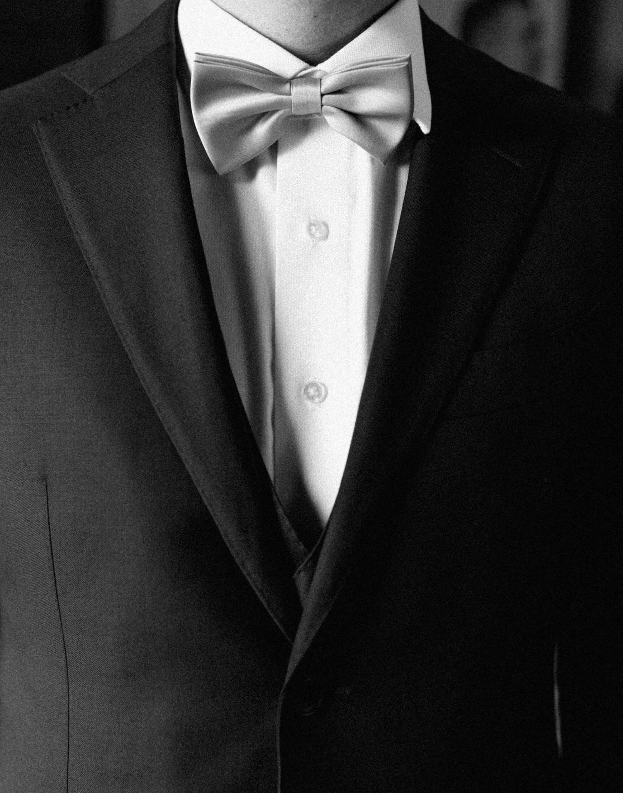 detail photo of all black and white groom wedding attire. 