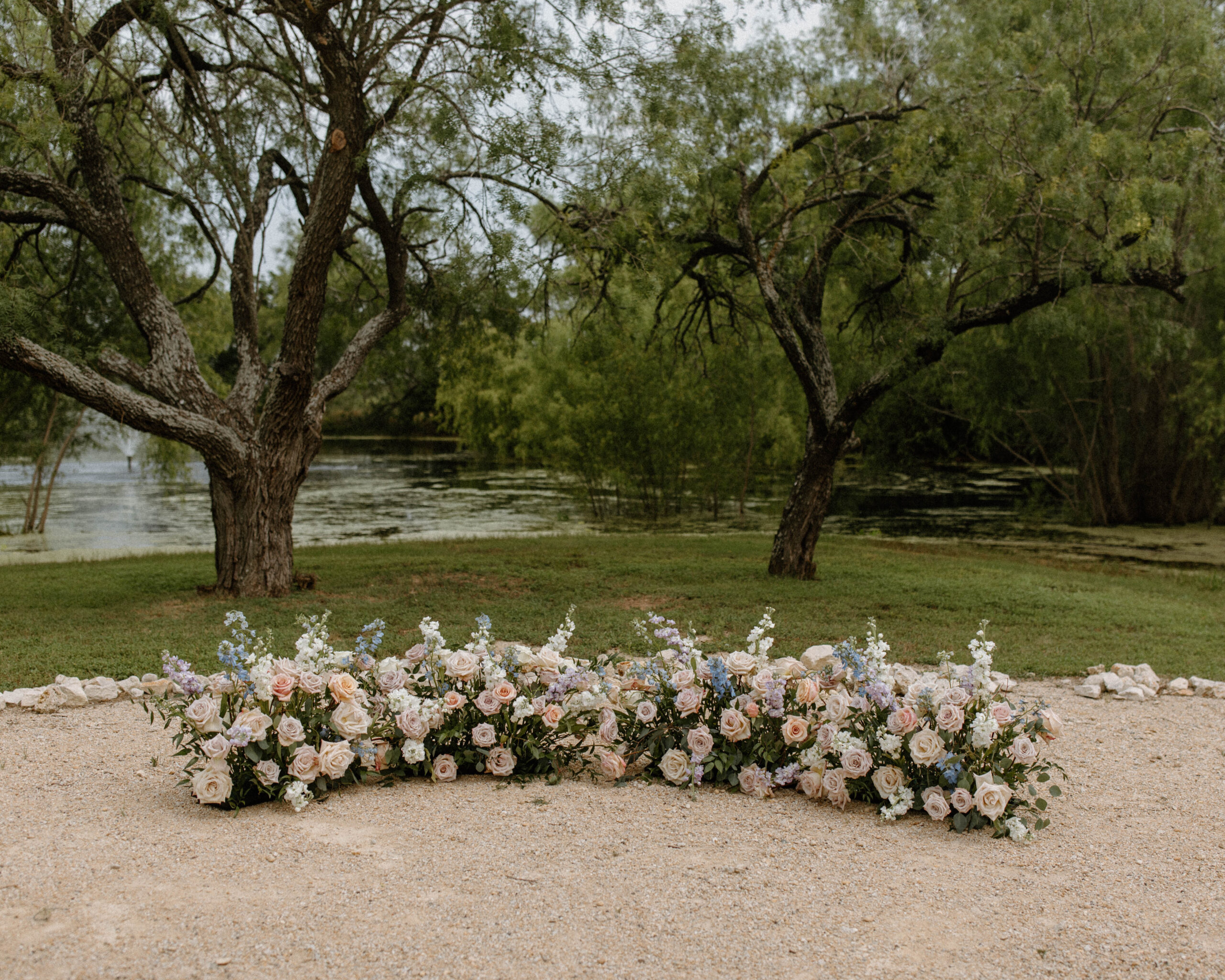 Floral Centerpiece for Wedding ceremony Arch. A photograph of a pastel blue and white flower ceremony pieces at Camino Real Ranch in Austin Texas. 