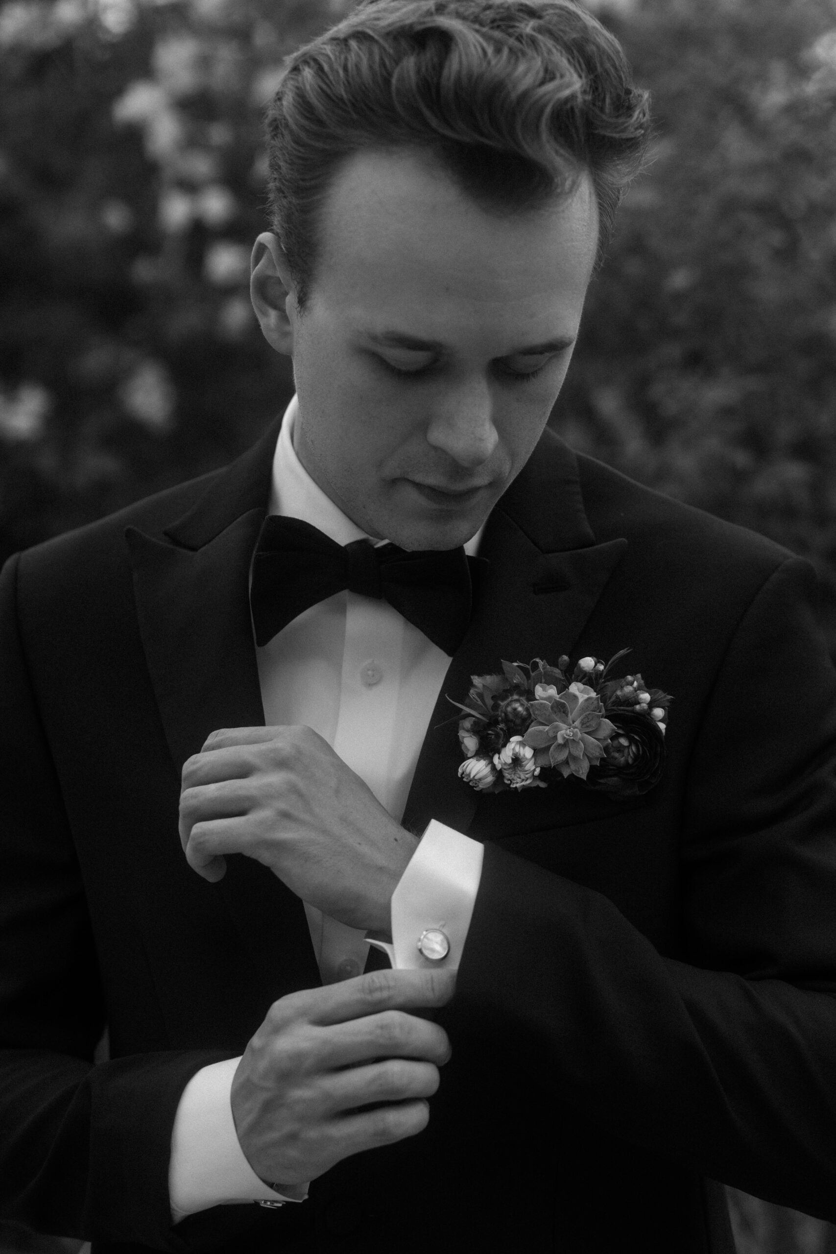 Photograph of a groom on his wedding day in a black tux. documentary wedding portraits in a garden at Villa Antonia Wedding Venue.