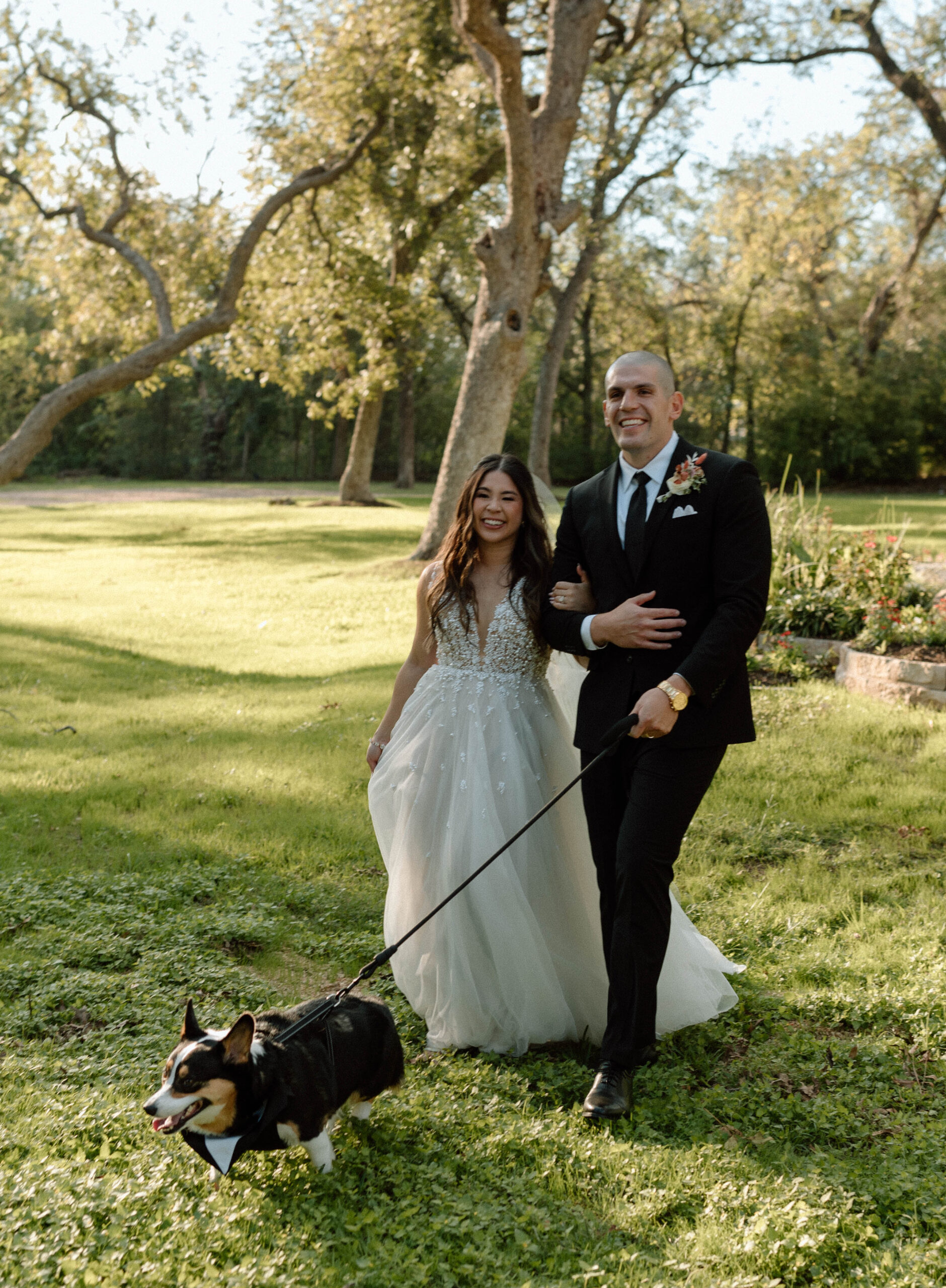 Married couple getting photos with their dog at their wedding. 