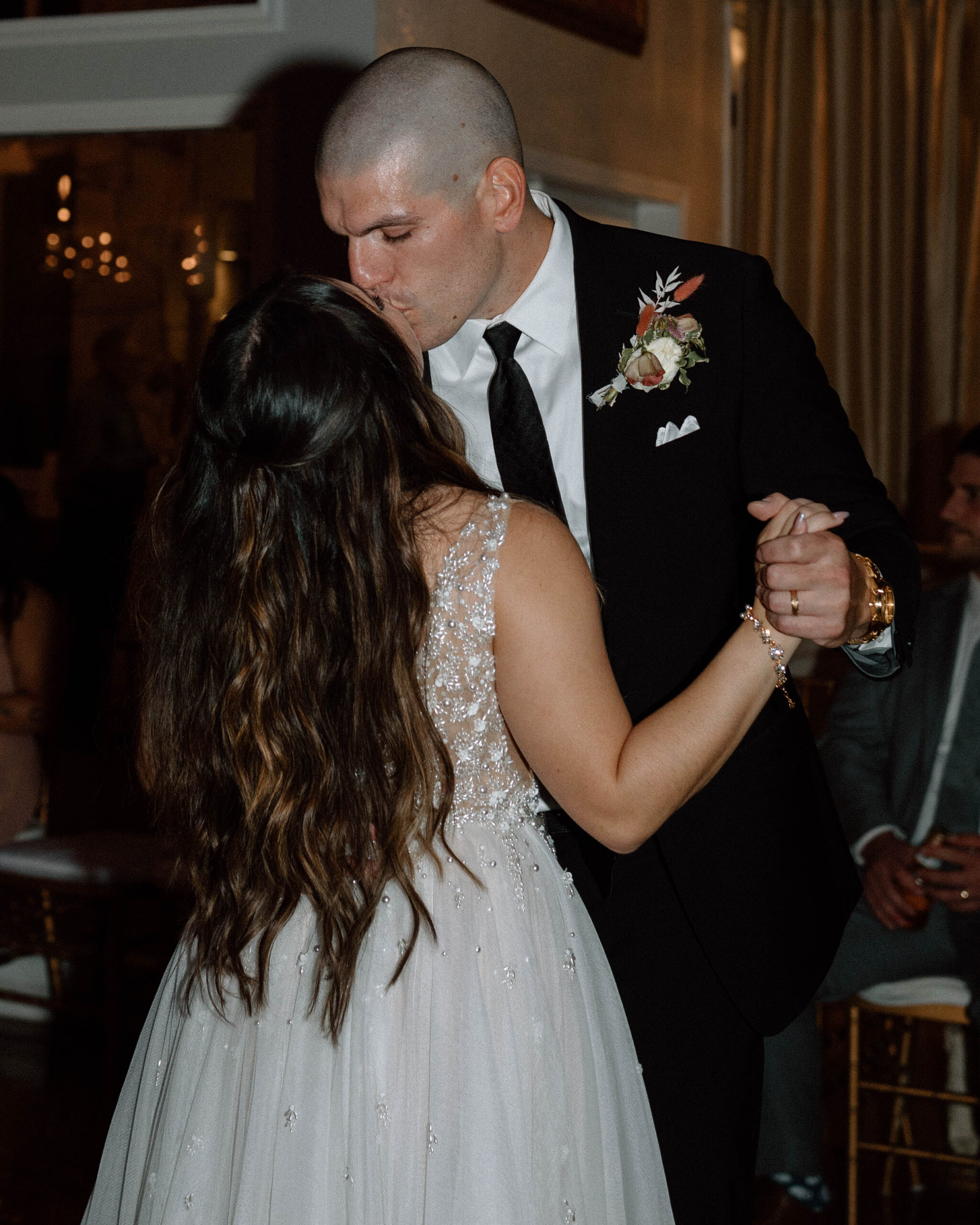 Heartfelt first dance moment captured at Casa Blanca Wedding, as the newlyweds share a tender embrace amidst twinkling lights and joyous celebration