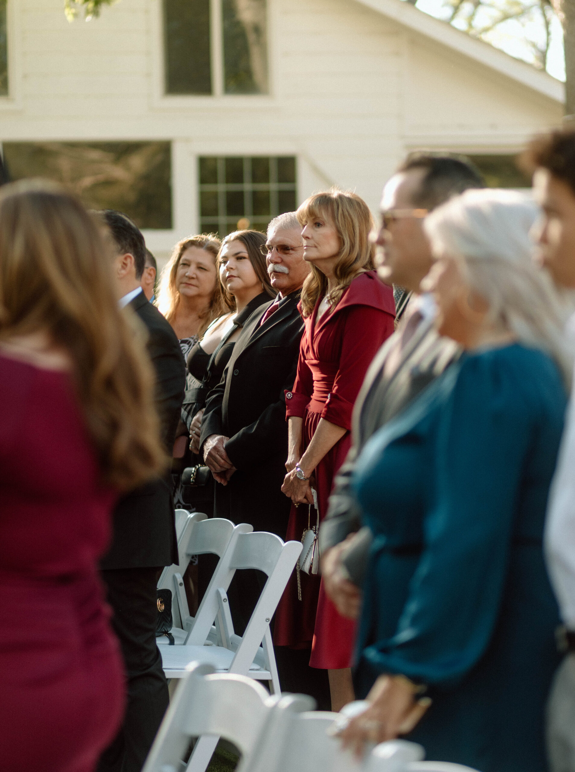 Candid photograph of wedding guests during a ceremony at Casa Blanca Wedding Venue. 