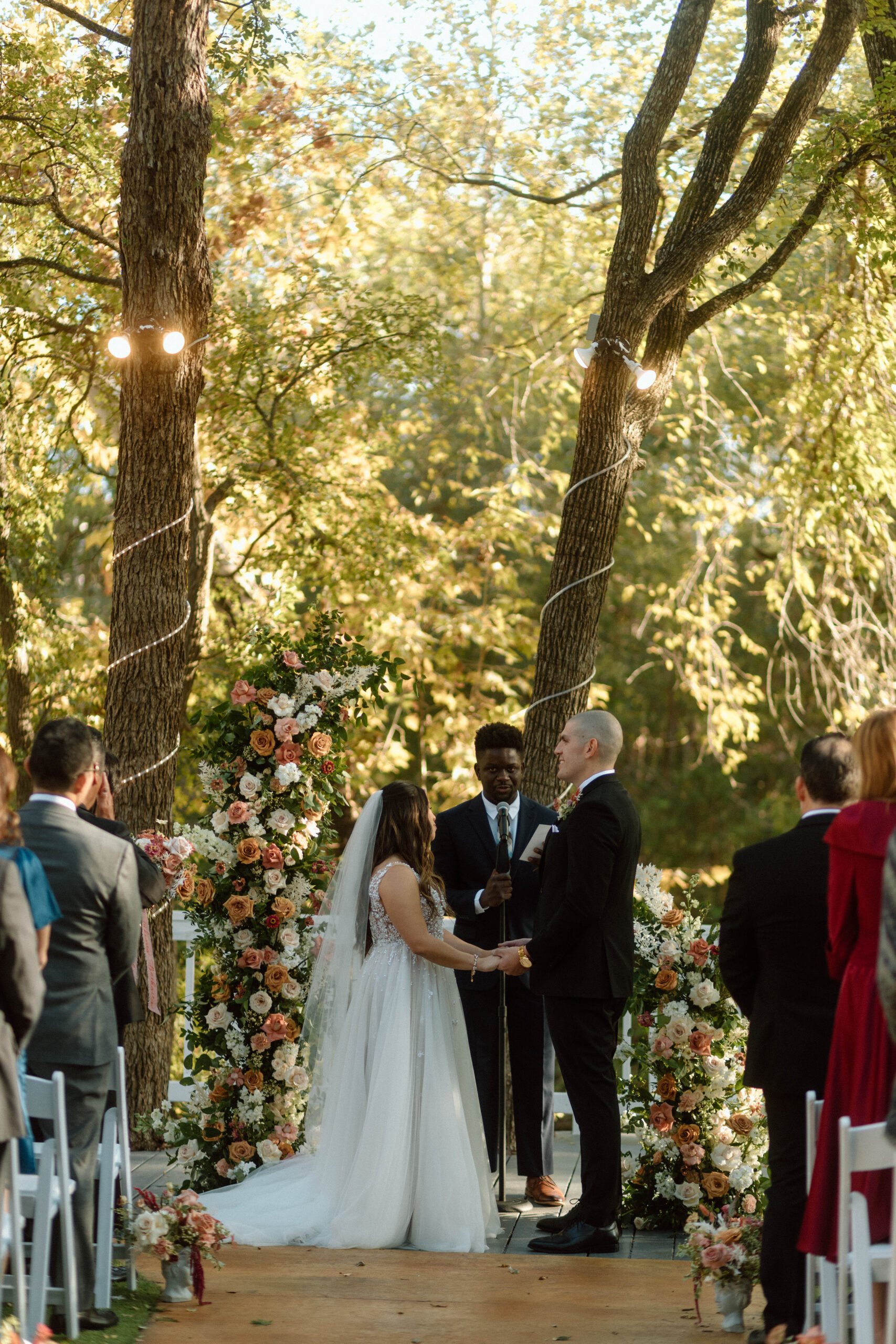 Breathtaking riverside garden ceremony at Casa Blanca Wedding in Austin, Texas, with autumnal foliage and elegant floral arrangements.