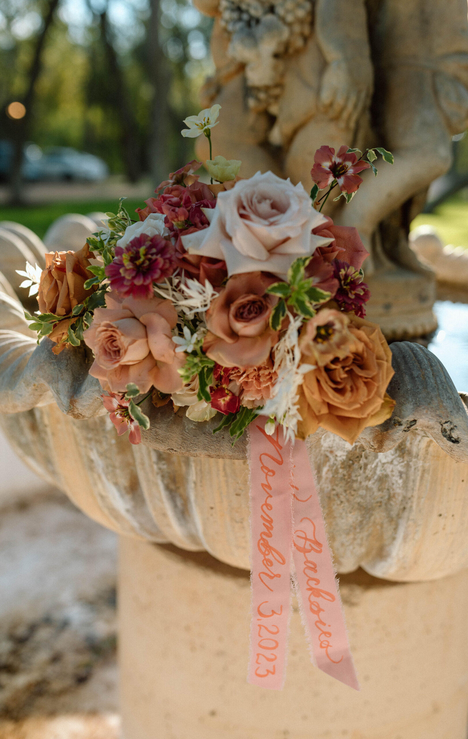 Wedding bouquet photograph with personalized floral ribbon. detail wedding floral photo on a fountain at Casa Blanca on Brushy Creek 